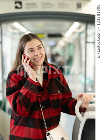 Girl emotionally talks on phone in tram car, getting to work 123281905