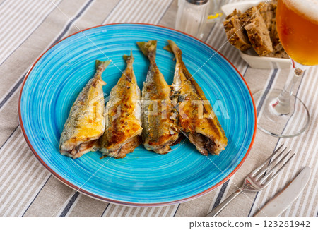 Fried carcasses of oceanic mackerel fish are laid out on plate Fried carcasses of oceanic mackerel fish are laid out on plate 123281942
