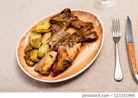 Baked rabbit with potatoes 123281966