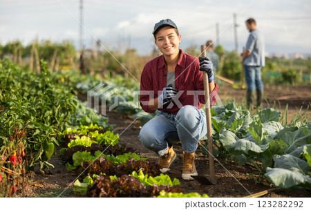Woman with a hoe in the garden 123282292