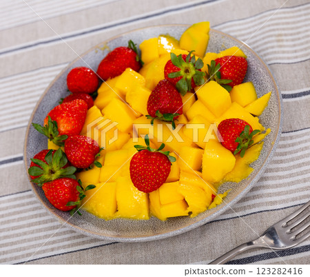 Mango pieces served with juicy strawberries 123282416