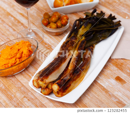 On rectangular plate - fried sweet green onions kalsot,supplemented jar of romesco sauce,red wine On rectangular plate - fried sweet green onions kalsot,supplemented jar of romesco sauce,red wine 123282455