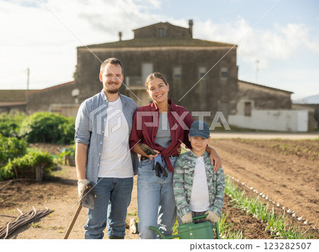Family of farmers standing in the garden Family of farmers standing in the garden 123282507