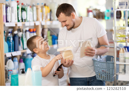 Schoolboy son and dad are choosing bast wisp in store 123282510