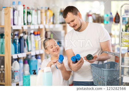 Man and boy choosing garbage bags in store 123282566
