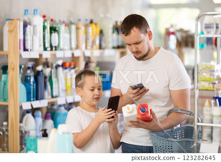 Man and boy scanning qr code for unclogging Man and boy scanning qr code for unclogging 123282645