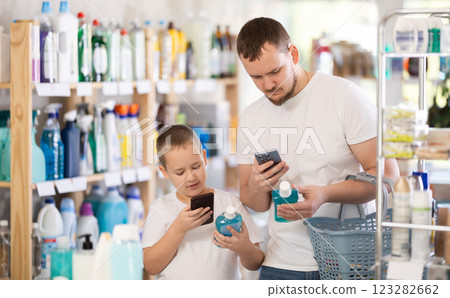 Dad and son scan barcode on packaging of mouthwash Dad and son scan barcode on packaging of mouthwash 123282662