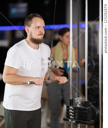 Man doing arm training Man doing arm training 123282874