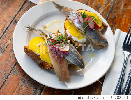 Dutch soused herring served on pieces of bread 123282913