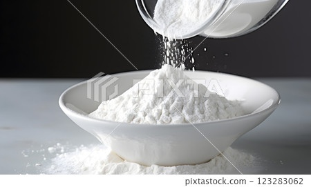 Pouring powdered sugar into bowl for baking ingredient concept 123283062
