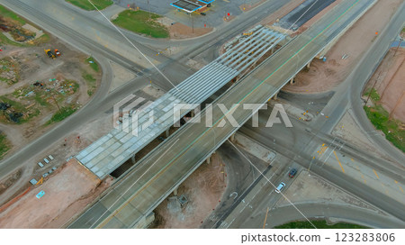 Aerial view of highway interchange construction with an overpass, nearby work areas. Aerial view of highway interchange construction with an overpass, nearby work areas. 123283806