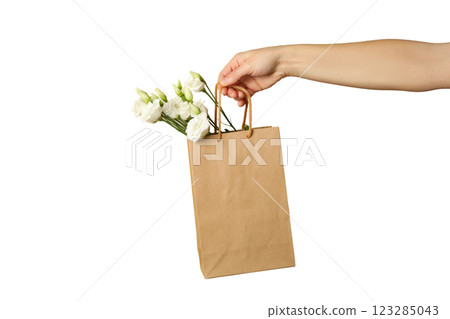 PNG, March 8. Kraft gift bag with flowers in hand, isolated on white background. 123285043