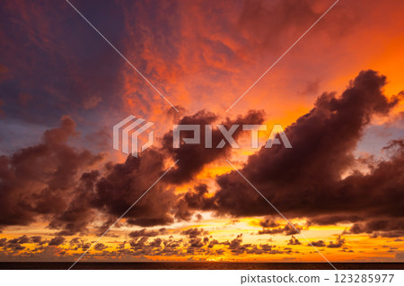 Amazing colorful clouds in sunset or sunrise sky over sea nature landscape background Amazing colorful clouds in sunset or sunrise sky over sea nature landscape background 123285977