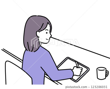 A woman drawing on a tablet PC with a touch pen in a cafe 123286031