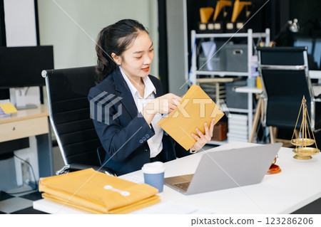 female lawyer celebrating success with documents at a desk, featuring a gavel, scales of justice, female lawyer celebrating success with documents at a desk, featuring a gavel, scales of justice, 123286206