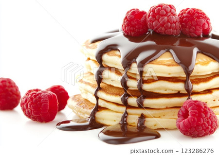 Stack of pancakes dripping with chocolate and topped with raspberries 123286276