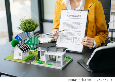Signing a contract. Client and broker agent, lease agreement, successful deal and Young business sitting at the desk Signing a contract. Client and broker agent, lease agreement, successful deal and Young business sitting at the desk 123286703