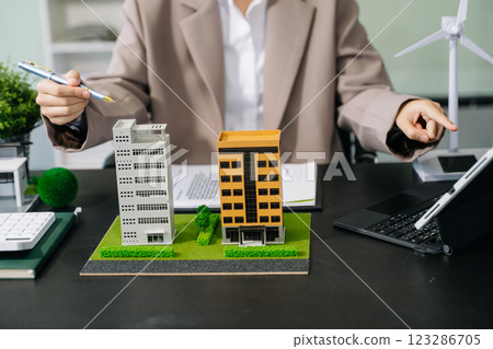 Real estate broker agent presenting and consult to customer to decision making sign insurance form agreement, home model Real estate broker agent presenting and consult to customer to decision making sign insurance form agreement, home model 123286705