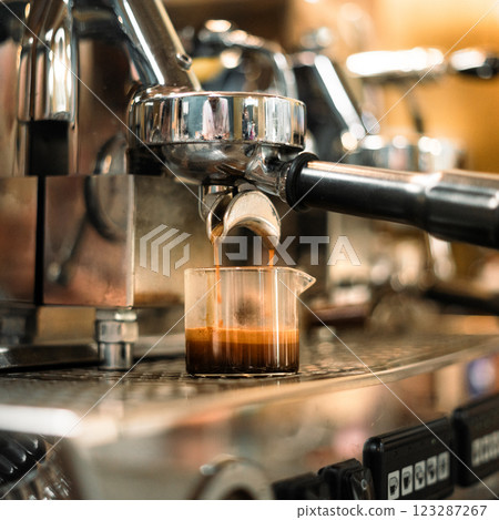 Espresso machine pouring hot coffee in a cafe 123287267