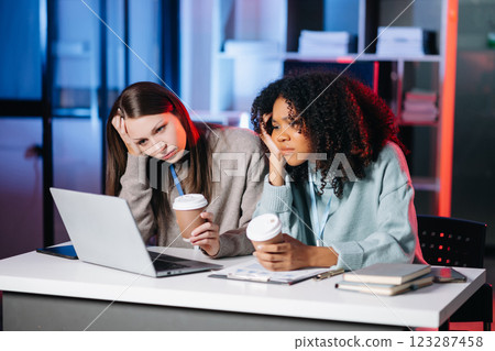 Two businesswoman discuss investment project working and planning strategy with tablet laptop computer Two businesswoman discuss investment project working and planning strategy with tablet laptop computer 123287458