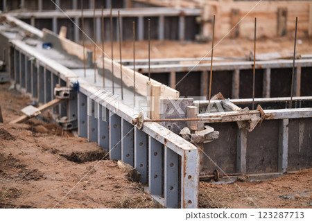 Construction of pile-grillage foundation. Monolithic foundation with metal reinforcement. Monolithic concrete foundation. House construction 123287713