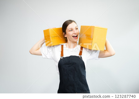 Caucasian woman smiling and holding package parcel box isolated on white background 123287740