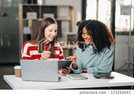 Businesswoman leading team working and using tablet and laptop computer with financial in office 123288041