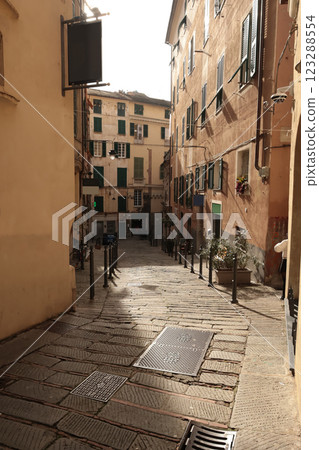 Traditional buildings and steps, pedestrianized narrow streets of old town. Genoa and medieval architecture of Italy. Windows and doors. Traditional buildings and steps, pedestrianized narrow streets of old town. Genoa and medieval architecture of Italy. Windows and doors. 123288554