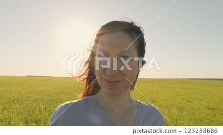 Natural Portrait Of A Beautiful Woman Standing In An Open Field. Portrait A Woman Rests And Smiles On A Meadow. Feeling Pleasure. Gimbal Stabilize. 123288686