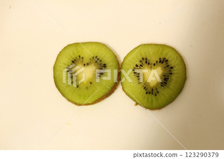Two pieces of kiwi on a white background top view place for text copyspace 123290379