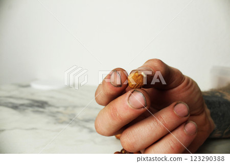 Hazelnuts in a person's hand. Choosing nuts for nutrition Hazelnuts in a person's hand. Choosing nuts for nutrition 123290388