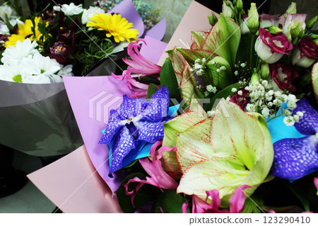 Bouquet of different flowers, lilies, roses, irises in a flower shop Bouquet of different flowers, lilies, roses, irises in a flower shop 123290410