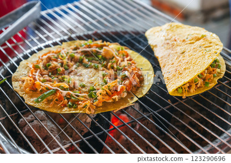 Vietnamese banh Xeo pancakes grilled at Asian street night market in Vietnam. Traditional Vietnamese street food Vietnamese banh Xeo pancakes grilled at Asian street night market in Vietnam. Traditional Vietnamese street food 123290696