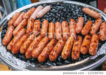 Grilled sausages on rocks at Asian night market. Street fast food in Asia in Vietnam Grilled sausages on rocks at Asian night market. Street fast food in Asia in Vietnam 123290703