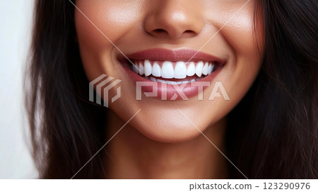 Radiant smile with healthy, white teeth, showcasing dental care and confidence. Attractive lips and skin tones enhance the overall appeal. 123290976