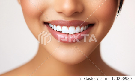 A radiant, healthy smile showcases bright, white teeth and soft, naturally colored lips, conveying confidence and well-being. 123290980