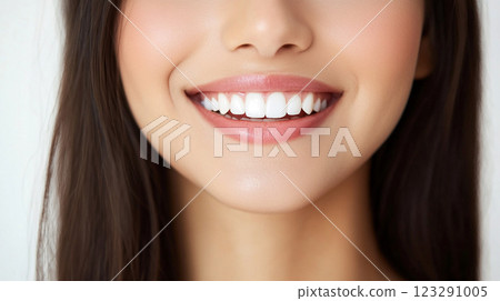 Close-up of a radiant woman smiling, showcasing her bright, white teeth with full, slightly pink lips. Healthy oral hygiene is displayed. Close-up of a radiant woman smiling, showcasing her bright, white teeth with full, slightly pink lips. Healthy oral hygiene is displayed. 123291005