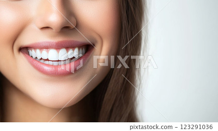 Close-up of a beautiful smile with straight, healthy, bright white teeth, showcasing dental health and a confident expression. The lips are tinted light pink. Close-up of a beautiful smile with straight, healthy, bright white teeth, showcasing dental health and a confident expression. The lips are tinted light pink. 123291036