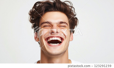 Euphoric laughter fills the air as a young man throws his head back in unrestrained joy, showcasing his infectious grin and carefree spirit. Euphoric laughter fills the air as a young man throws his head back in unrestrained joy, showcasing his infectious grin and carefree spirit. 123291239