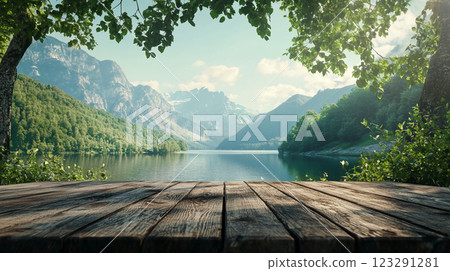 Scenic mountain lake view from a wooden deck surrounded by lush foliage, evoking peace and natural beauty. 123291281