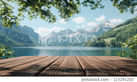 Serene lake vista with snow capped mountains, lush forests and wooden deck. Perfect scenic escape. Tranquil and peaceful landscape backdrop. 123291283