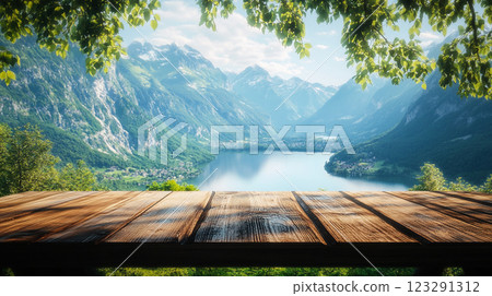 Scenic View: A weathered wooden table overlooks a breathtaking mountain range, pristine lake, and lush greenery, perfect for relaxation. Scenic View: A weathered wooden table overlooks a breathtaking mountain range, pristine lake, and lush greenery, perfect for relaxation. 123291312