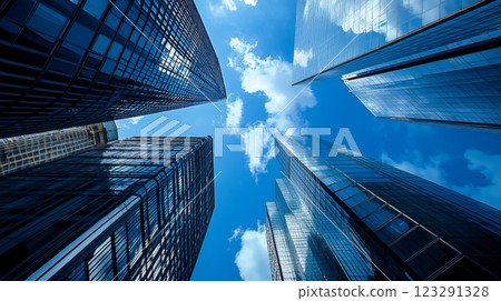Skyscrapers pierce the bright blue sky, reflecting clouds in their glass facades, symbolizing modern urban architecture and growth. Skyscrapers pierce the bright blue sky, reflecting clouds in their glass facades, symbolizing modern urban architecture and growth. 123291328