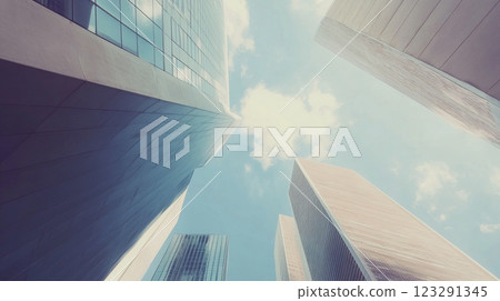 Skyscrapers reaching towards the sky, their geometric designs contrasting with the soft clouds in the blue sky above. Urban landscape. 123291345