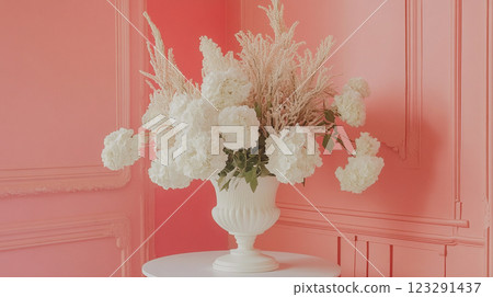 Elegant floral arrangement in a white vase, set against a monochromatic coral room, creates a visually appealing, serene composition. 123291437