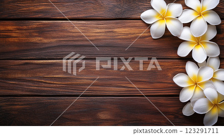 Plumeria flowers adorn a rustic wooden surface, creating a serene and natural composition. Perfect for backgrounds or tranquil themes. Plumeria flowers adorn a rustic wooden surface, creating a serene and natural composition. Perfect for backgrounds or tranquil themes. 123291711