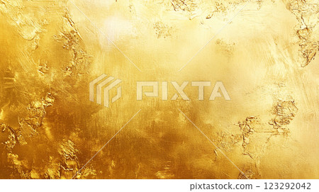 An abstract image showcases a golden surface with a textured, almost metallic appearance, creating a sense of opulence and artistic depth. 123292042