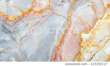 Elegant marble texture featuring a blend of white, peach, and gray tones accentuated with intricate golden vein-like patterns. 123292117