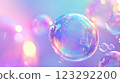 Iridescent bubbles float against a soft, pastel gradient. Light refracts and dances across their surface, creating a whimsical ambiance. 123292200