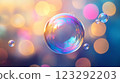 Iridescent bubbles float against a soft, blurred background of warm bokeh lights, creating a dreamy and ethereal atmosphere. 123292203